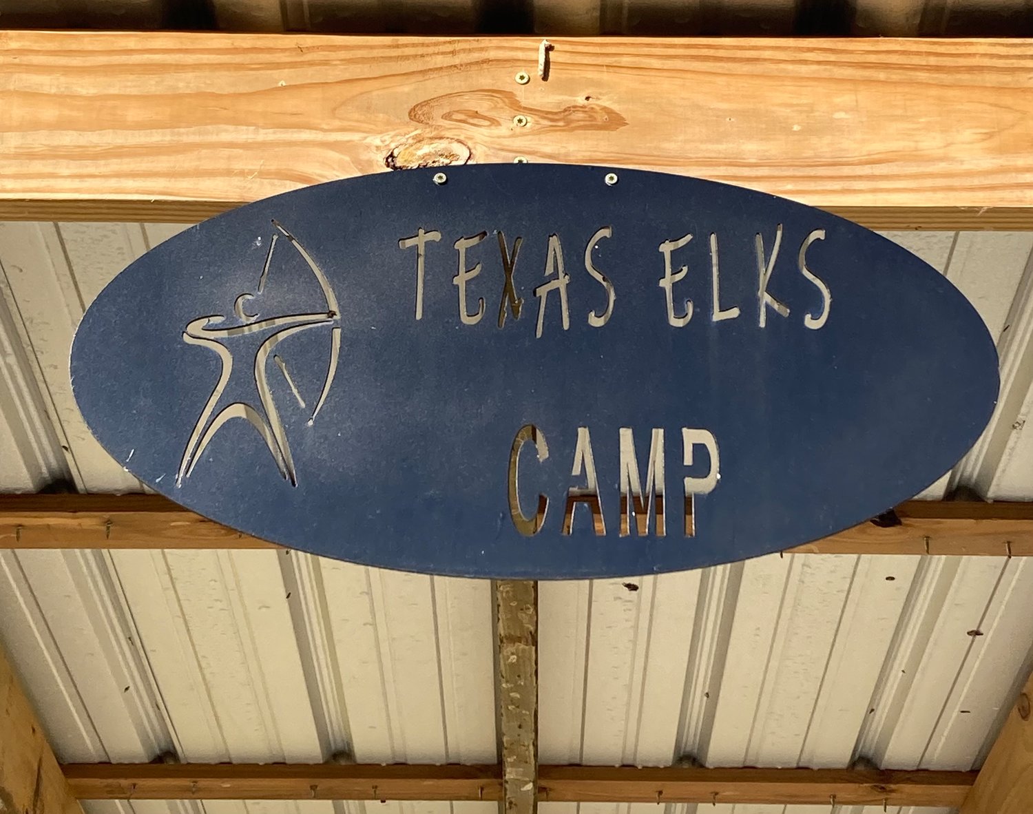This camp sign is posted on the shelter near the field where campers practice archery.
